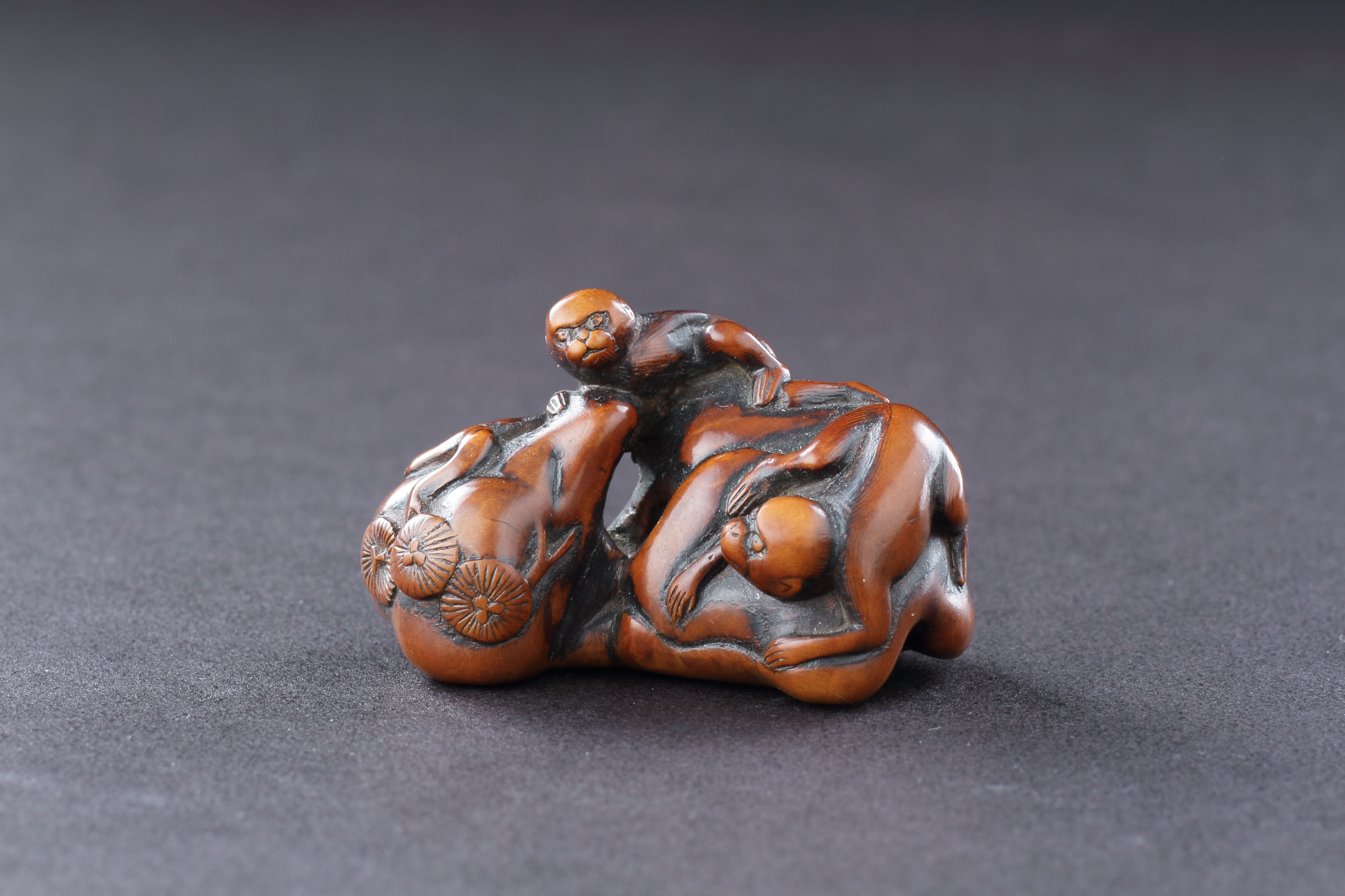 Japanese Boxwood Netsuke of Two Monkeys Climbing over a Rock with Bonsai Prunus Trees